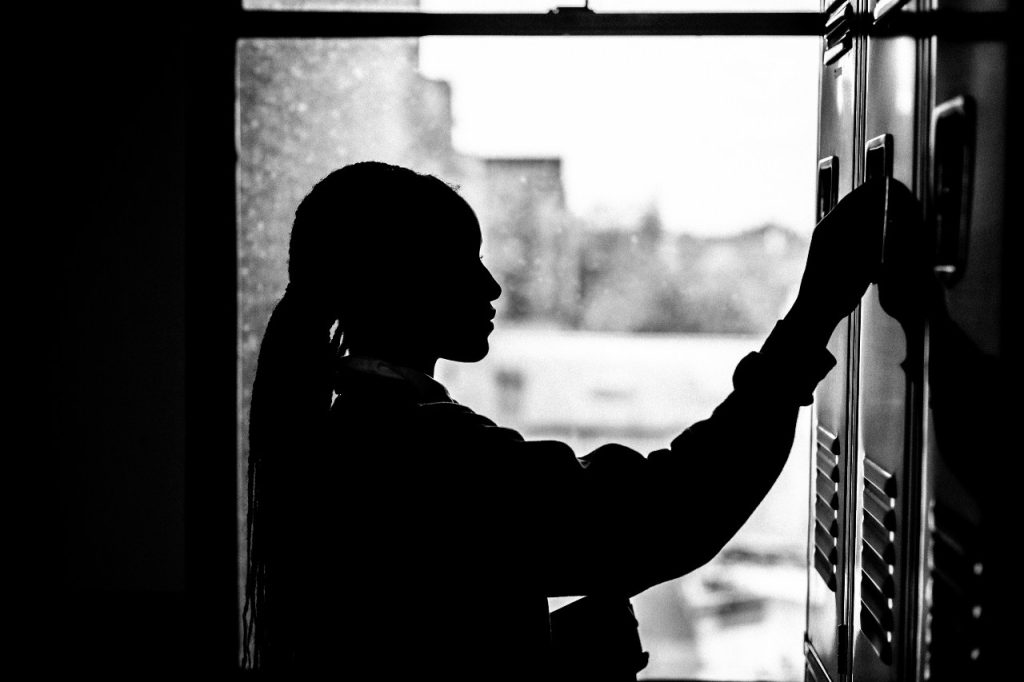 8th grade student at locker